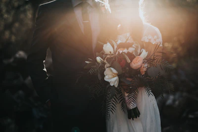 Bride and groom walking through a vineyard at golden hour